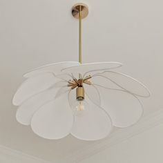 a chandelier hanging from the ceiling in a room with white walls and ceilings