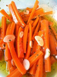 carrots with garlic and seasoning in a white bowl