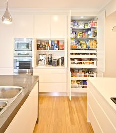 the kitchen is clean and ready for us to use it's shelves are full of food