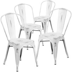 four white chairs sitting next to each other