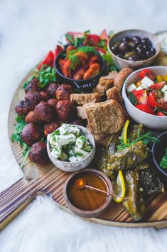 a wooden platter filled with different types of food