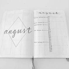 an open notebook with the word august written in cursive writing