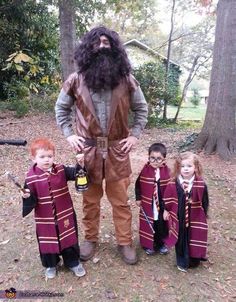 a man with long hair and beard standing next to three children