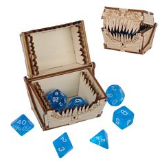 an open wooden box with blue dices in it and two smaller ones on the inside