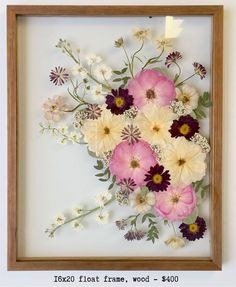 a wooden frame with flowers in it