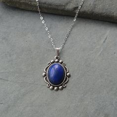 A pretty vintage style Lapis Lazuli Pendant The Lapis Lazuli stone measures 14mm x 10mm and is set in a pretty decorated Sterling silver plated brass vintage style setting that measures 20mm x 17mm. It suspends from a sterling silver fine Belcher chain that has a spring ring fastening and is available in a choice of 16", 18",20"  or 22" length. Your necklace will arrive gift boxed. IMPORTANT IMFORMATION- Due to the new GPSR rules I am currently unable to ship to Northern Ireland. Sorry for any i Lapis Lazuli Pendant, Black Onyx Necklace, Onyx Necklace, Lapis Lazuli Stone, Cute Necklace, Oval Pendant, Sterling Silver Necklace, Spring Rings, Gemstone Pendant