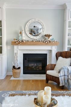 a living room filled with furniture and a fire place in front of a mirror on the wall