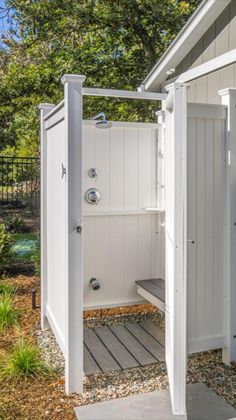 an outdoor shower in the shape of a shed