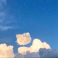 two hello kitty heads are floating in the sky above some fluffy clouds and blue skies