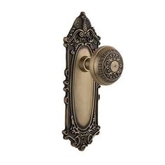 an antique style door handle with ornate design