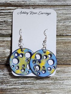 Holey Circles with Blues and Yellow; unique one of kind enameled earrings. All products include exchange of equal or lesser value if in 30 days of purchase if front glass chips away noticeably showing copper.  Send me a picture of the earrings and your contact information. Cadmium-free Blue Earrings As Gift, Blue Circle Earrings As Gift, Unique Blue Hypoallergenic Earrings, Blue Circular Earrings For Gifts, Blue Circle Earrings For Gifts, Artsy Blue Round Jewelry, Fun Blue Hand Painted Earrings, Whimsical Blue Hand Painted Earrings, Artsy Blue Enamel Jewelry