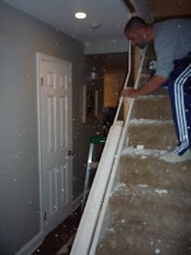 a man is climbing up the stairs in his house with snow falling all over him