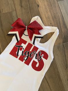 With cheer tryouts right around the corner, or Friday Spirit Day, this tank with matching bow combo is perfect for game day. Tank and bow only. Tank is a white or black Bella and canvas Razorback tank top. TO PURCHASE : Leave message in comments high school initials and mascot name along with school colors. Please specify size (youth or ladies) and color of tank top. Team discount for orders of 10 or more. Just message me so I can make a separate listing personally for you. Cheerleading Practice Wear, Cheer Camp Shirts, Cheer Team Shirts, Cheer Practice Outfits, Dance Team Uniforms, Cheer Practice Wear, Dance Team Shirts, Cheer Coach Shirts, Cheer Tops