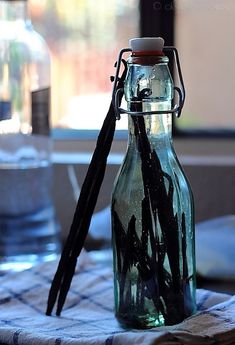 an empty glass bottle sitting on top of a table