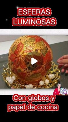 an image of a golden hat with red and yellow flowers on it's top