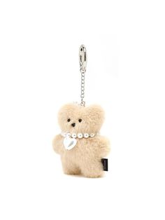 a small teddy bear with pearls on it's neck is hanging from a chain