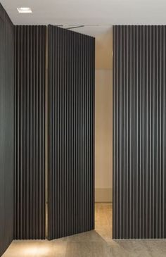 an empty room with vertical blinds on the walls