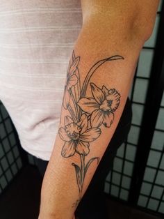 a woman with a flower tattoo on her arm