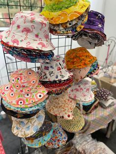 many hats are hanging from a wire rack