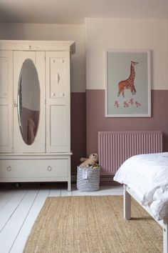 a bedroom with pink walls and white furniture