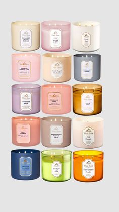 many different types of candles with labels on the lids and in each one's colors