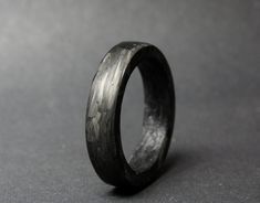 "This listing is for a handmade ring made with short carbon fibers in epoxy, giving the ring a unique look  Carbon fiber is a highly durable material! It's used in the aerospace industry and in race cars. -FREE SHIPPING WORLDWIDE- Every ring is handmade to order, no mass production. Each ring is made with a lot of care and time spent on every part of the process to make sure they all stand a very high standard. If you would like to customize the ring, feel free to use the \"request a custom order\" button on the shop, custom sizes, widths are available. Please note the turnaround time mentioned in the banner on top of the home page, if you need an order in a rush please contact me, it's usually available. Custom orders - build your ring I love custom orders; If you want a specific type of Carbon Fiber Ring, Forged Carbon Fiber, Carbon Fiber Rings, Antler Ring, Wood Stone, Mass Production, Handmade Ring, Custom Orders, Jewelry Shop