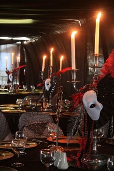 the table is set with silverware and candles