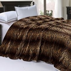 a tiger print comforter on a bed in a bedroom