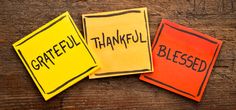 three colorful sticky notes with the words grateful, grateful and happy written on them in black ink