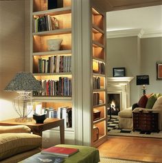 a living room filled with furniture and bookshelves