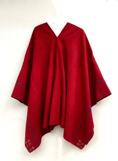 "Measures 160cm. x 160cm. \"We traveled through the southern Peruvian Andes\" Looking for vintage fashion, exclusive to the time, that preserves its original color and designs. It is almost impossible to find an exactly the same textile because it is 100% handmade. It is a very nice red poncho worked with natural dyes from the area, with blue lines, very warm, worked with sheep's wool, this work is handmade from the time. This poncho was made in a house in the close center of southern Peru. You Traditional Handwoven Poncho For Fall, Traditional Long Sleeve Poncho, Traditional Red One-size Poncho, Red Folk Style Poncho For Fall, Folk Style Red Poncho For Winter, Traditional Red Poncho For Fall, Bohemian Alpaca Shawl For Winter, Traditional Alpaca Shawl One Size, Traditional Red Fall Poncho