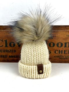 These are adorable little folded brim hats adorned with mini unstuffed faux fur poms.The hats measure 4" tall (not including the pom) x 3" Made from 100% wool yarn with suede tags, metal rivets and a suede tie for hanging.Listing is for 1 Mini Hat Ornament Knit Hat And Scarf, Tiny Hat, Hat Ornaments, Tweed Scarf, Hat Ornament, Leather Tags, Mini Hat, Malabrigo Yarn, Brim Hats