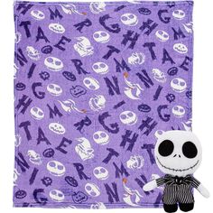 a purple and white blanket with jack skellingy on it