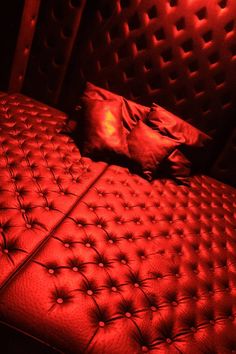 a red light shines on an upholstered bed