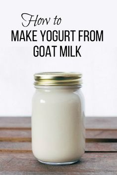 a glass jar filled with yogurt sitting on top of a wooden table