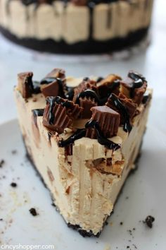 a piece of cake with chocolate and cream toppings on it sitting on a plate