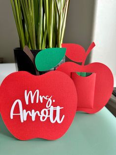 an apple shaped planter sitting on top of a table