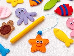 an assortment of felt sea animals on a white surface