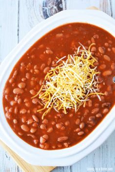 a white bowl filled with beans and cheese