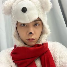 a person wearing a white teddy bear hat and scarf