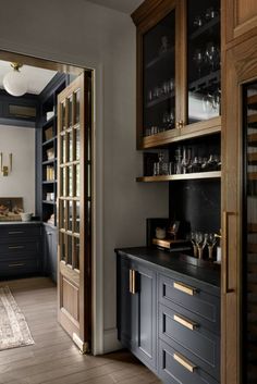 a kitchen with wooden cabinets and black counter tops, along with an area rug on the floor