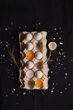 an overhead view of eggs in cartons on a black surface