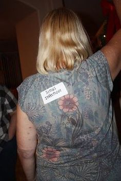 the back of a woman's shirt with a sticker on it