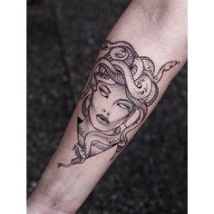 a woman's arm with a tattoo on it and an octopus around her neck