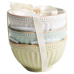 a stack of bowls with ribbons tied around them