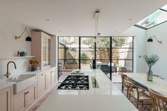 an open kitchen and dining room with skylights