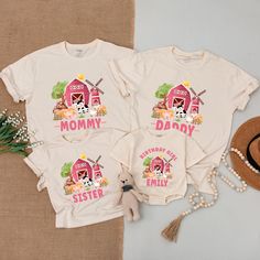 three t - shirts with the words mommy, daddy and baby printed on them next to a straw hat