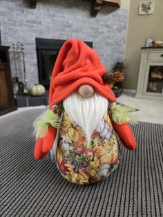 a stuffed gnome sitting on top of a carpet