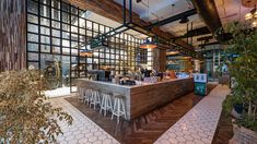 the inside of a restaurant with tables and stools