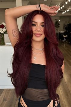 This sumptuous burgundy hairstyle showcases a deep, vibrant shade that gracefully blends red and purple hues, emanating a warm and refined aura. The tresses cascade in long, gentle waves, adding volume and movement while accentuating the multidimensional color and lustrous finish. It's a versatile look that can be styled to suit - Click to see more of 39 Stunning Burgundy Hair Color Ideas to Suit Every Look. and follow us for more hairstyle ideas. // Photo Credit: Instagram @loucaspormarsala Red Rose Hair Color, Burgundy Hair Blowout, Dark Magenta Hair Burgundy, Dark Roots With Red Hair, Purple Red Hair Burgundy, Fall Hair Color Inspiration, Hair Inspo Color Long, Dark Red Hair With Bright Red Highlights, Burgundy Hair Tan Skin